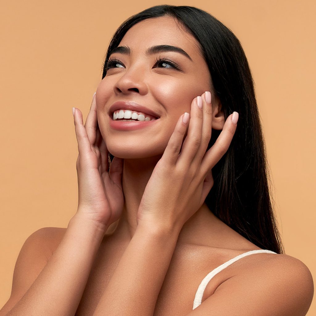 Woman touching her face while smiling