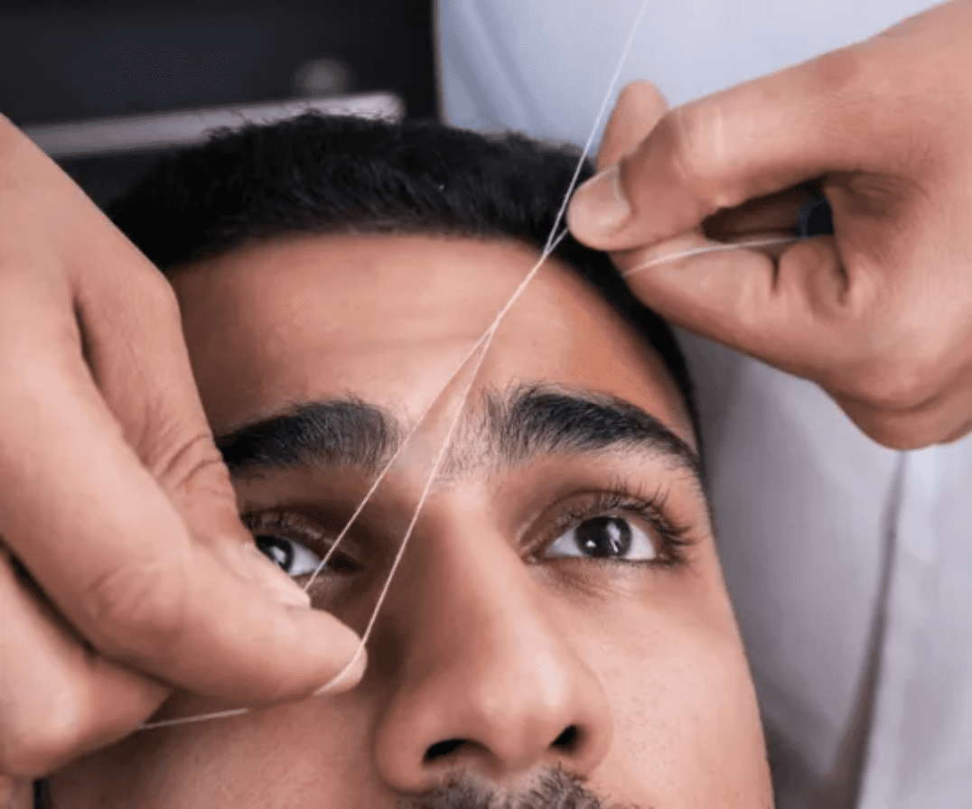 Man getting brow hair removed