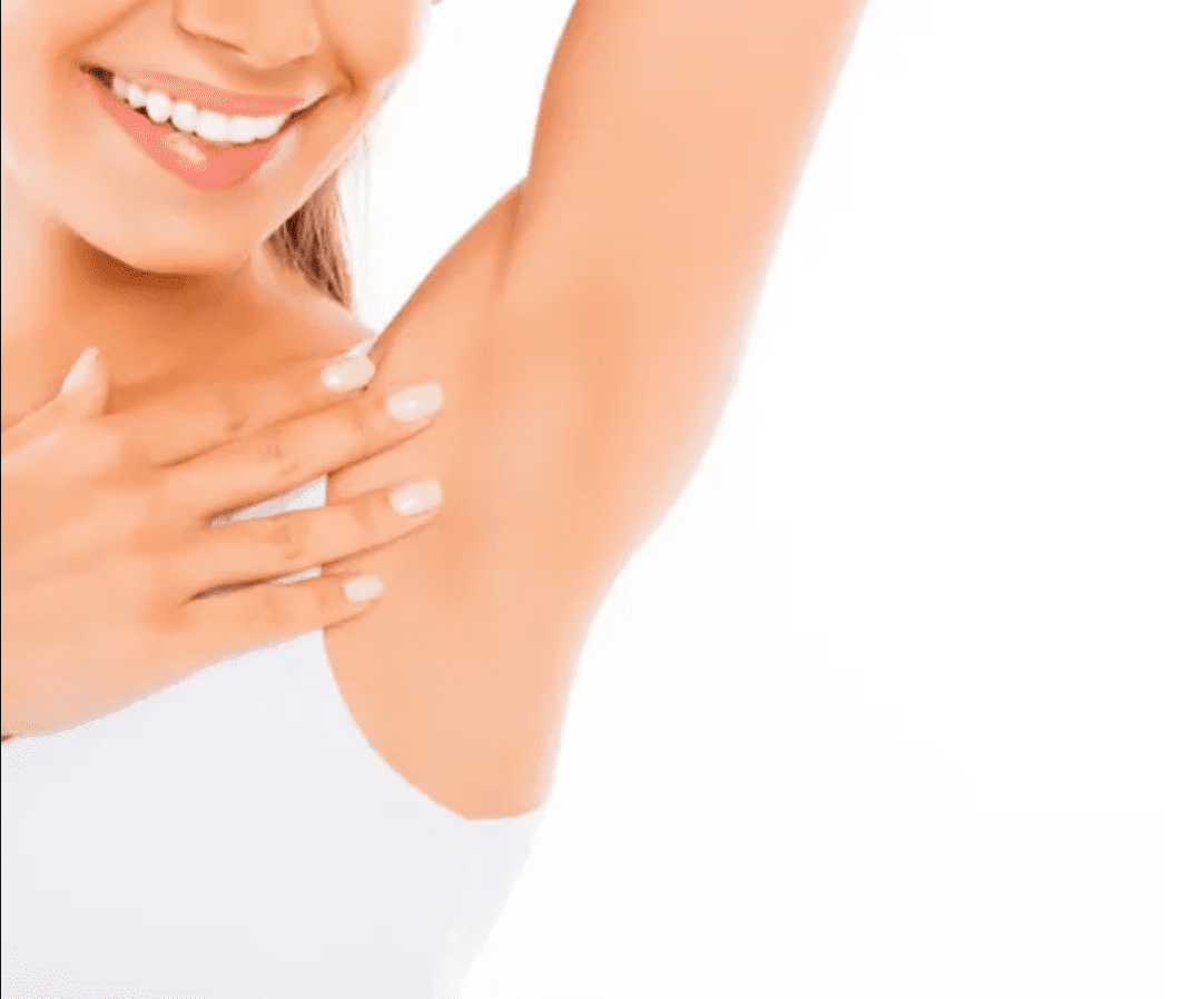 Smiling woman touching her hairless armpit