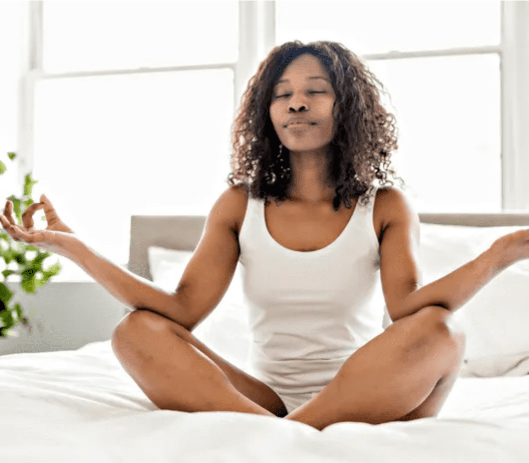 Woman meditating in bed